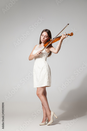 Beautiful young woman playing violing