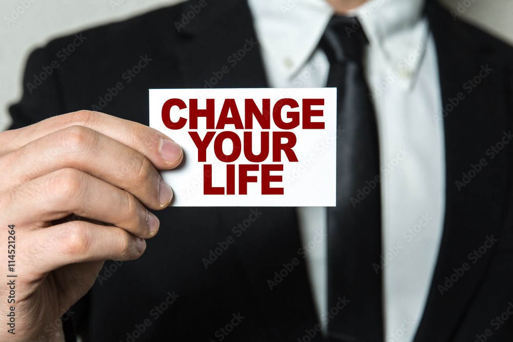 Business man holding a card with the text: Change Your Life Business man holding a card with the text: Change Your Life