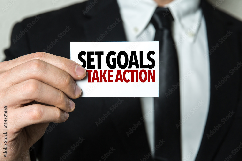 Business man holding a card with the text: Set Goals Take Action Business man holding a card with the text: Set Goals Take Action