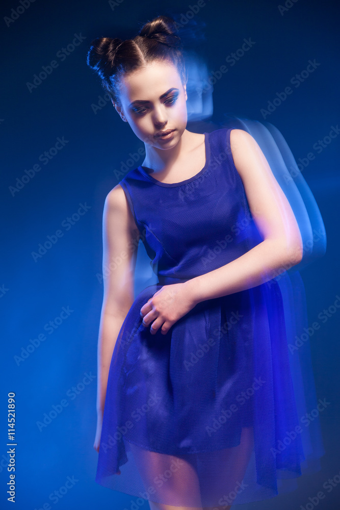 Woman in blue dress with hairstyle and make-up Woman in blue dress with hairstyle and make-up