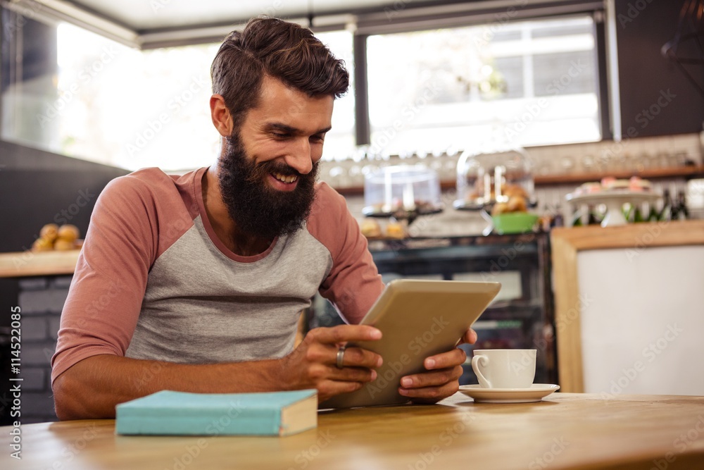 Man using a tablet sitting Man using a tablet sitting