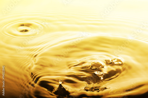 Liquid gold drop and ripple ,abstract background photo