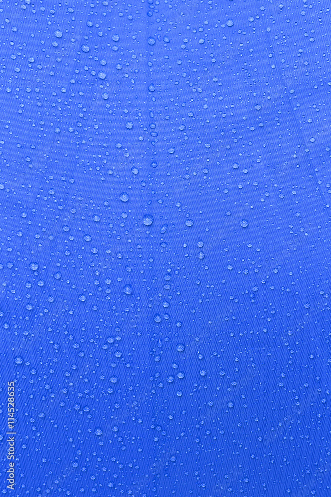 Rain water drop on blue background, vertical style