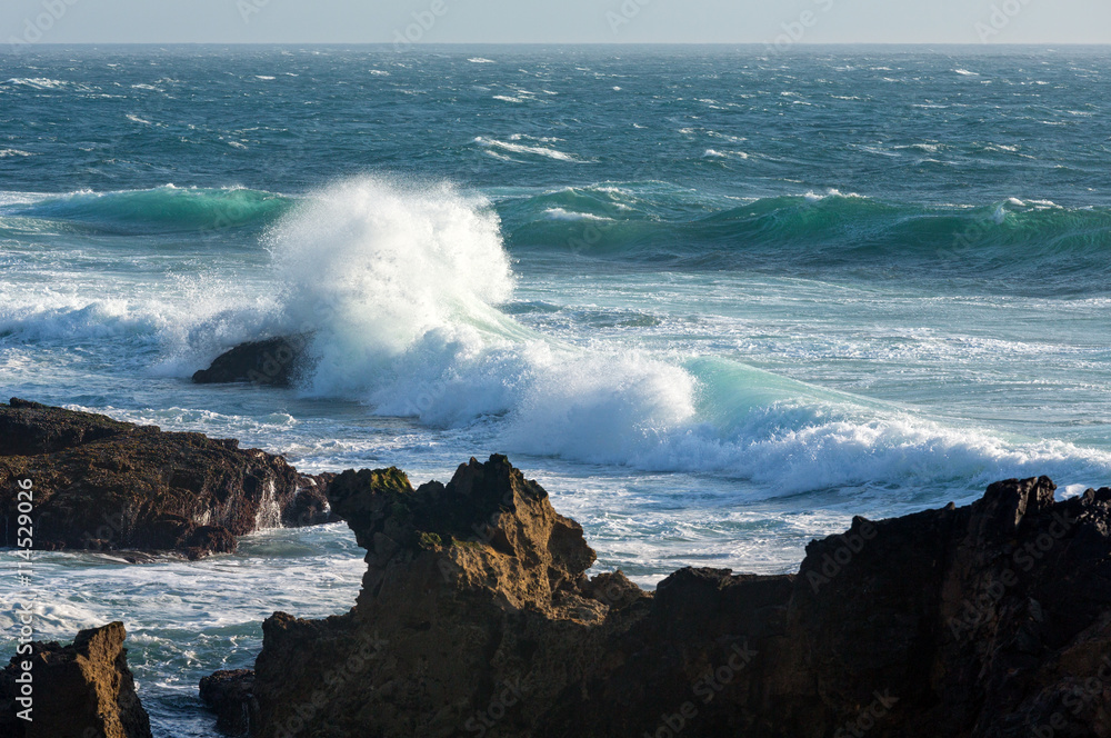 Waves breaking on rocky coast.