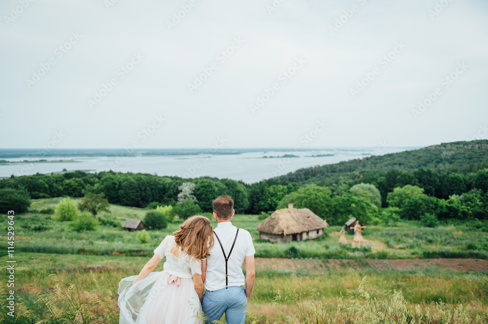 Happy Bride and groom walking on the green grass Happy Bride and groom walking on the green grass