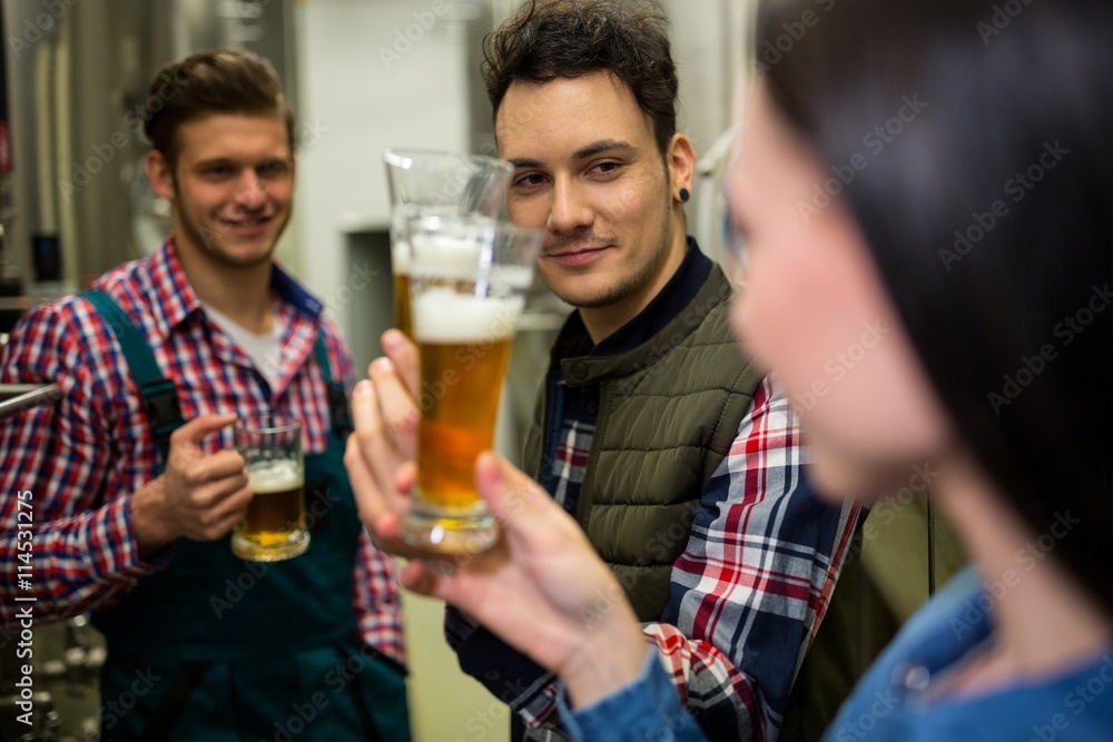 Brewers testing beer at brewery factory Brewers testing beer at brewery factory
