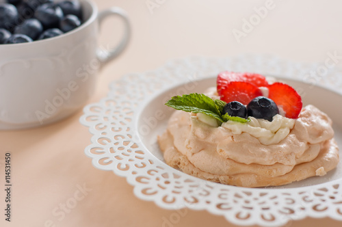 Anna Pavlova cake with strawberries, blueberries and cream cheese