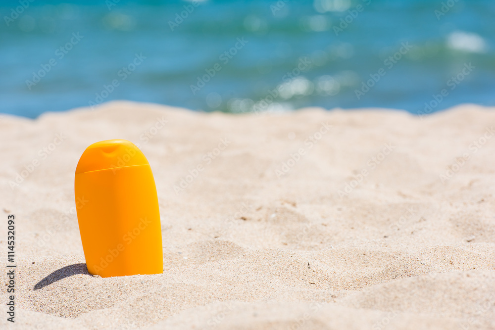 Sunscreen bottle on the beach Sunscreen bottle on the beach