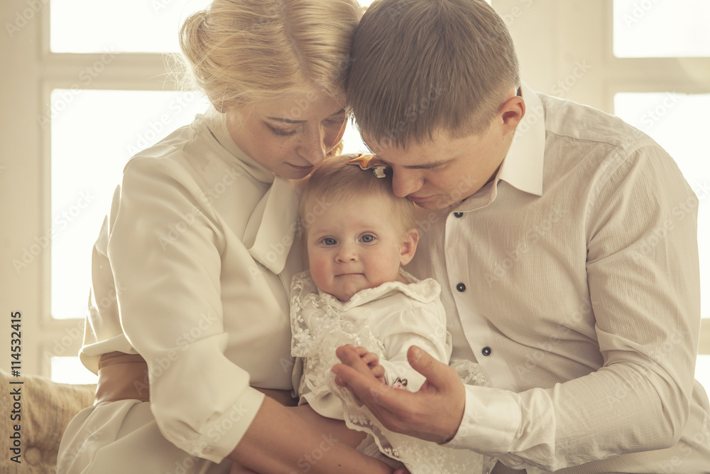 Family, mom, dad and daughter embrace together beautiful and hap Family, mom, dad and daughter embrace together beautiful and hap