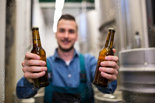 Photography Brewer holding two beer bottle