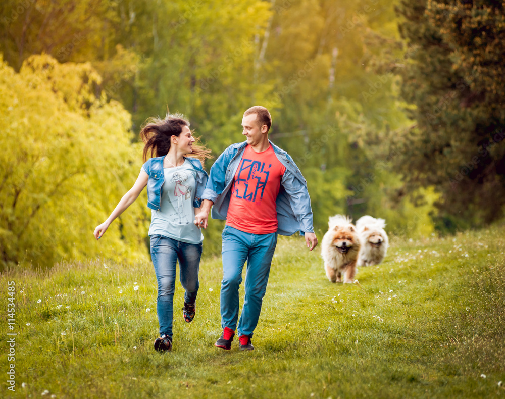 Young couple with the dogs in the park.