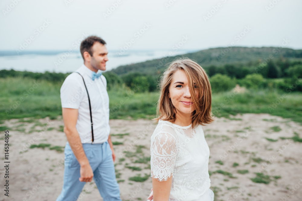 Happy Bride and groom walking on the green grass Happy Bride and groom walking on the green grass