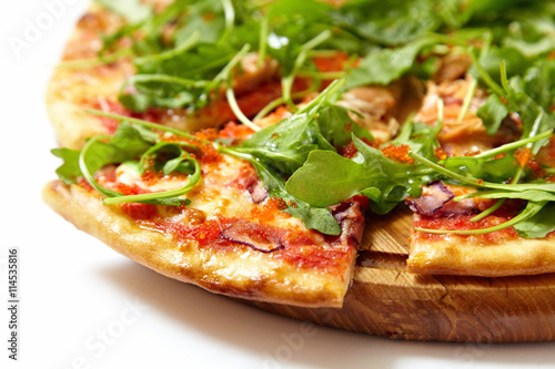 Pizza with seafood and arugula isolated on white