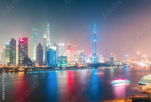 Aerial panoramic view over a big modern city by night. Shanghai  China. Nighttime skyline with illuminated skyscrapers.