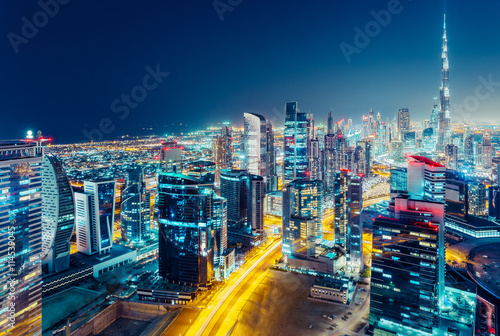 Aerial view over a big modern city at night. Business bay, Dubai, United Arab Emirates.