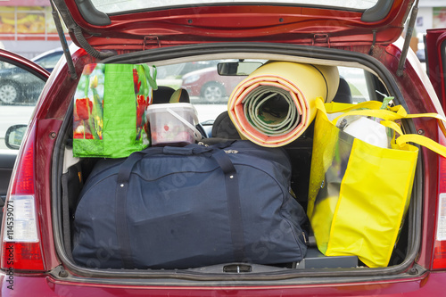 bags and things in the trunk of a car