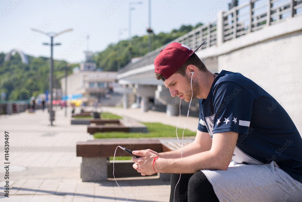 man using mobile technology during outdoors exercises