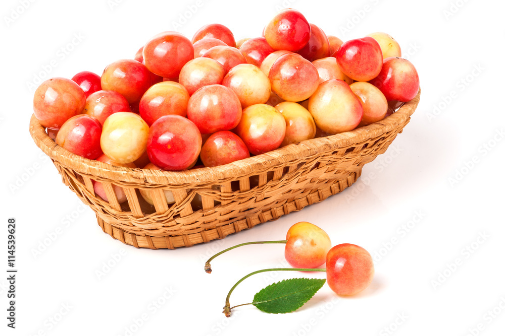 yellow cherries in a wicker basket isolated on white background yellow cherries in a wicker basket isolated on white background