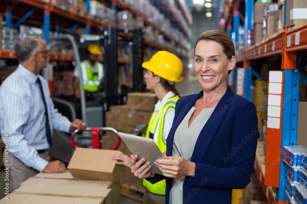 Business woman standing in front warehouse worker Business woman standing in front warehouse worker