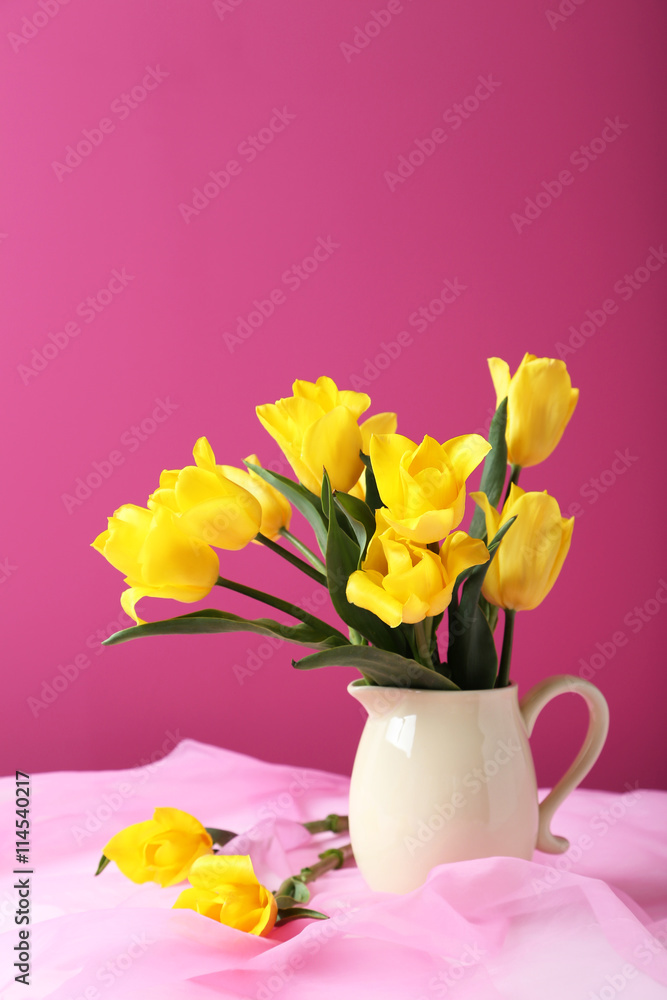 Bouquet of yellow tulips on a pink background