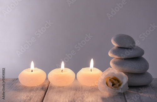 White spa stones with candles on dark background
