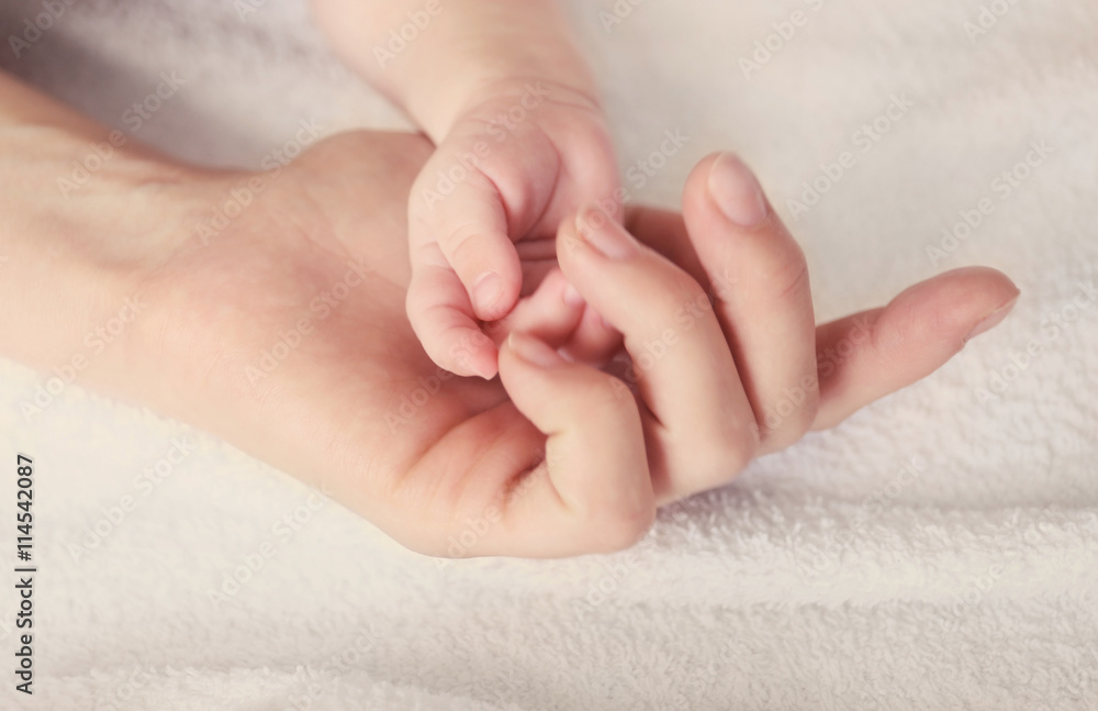 Child and female hand, closeup