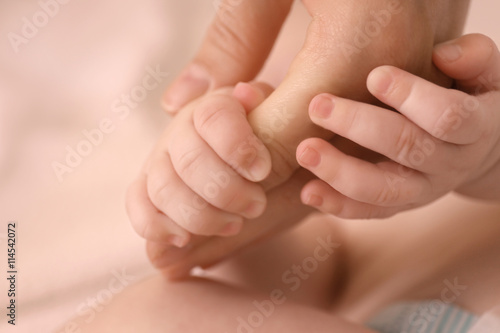 Child hand holding parent hand, closeup © Africa Studio