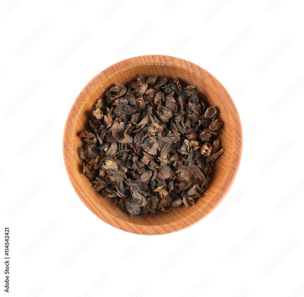 Dried basil (rayhon) in small wooden bowl isolated on white Dried basil (rayhon) in small wooden bowl isolated on white