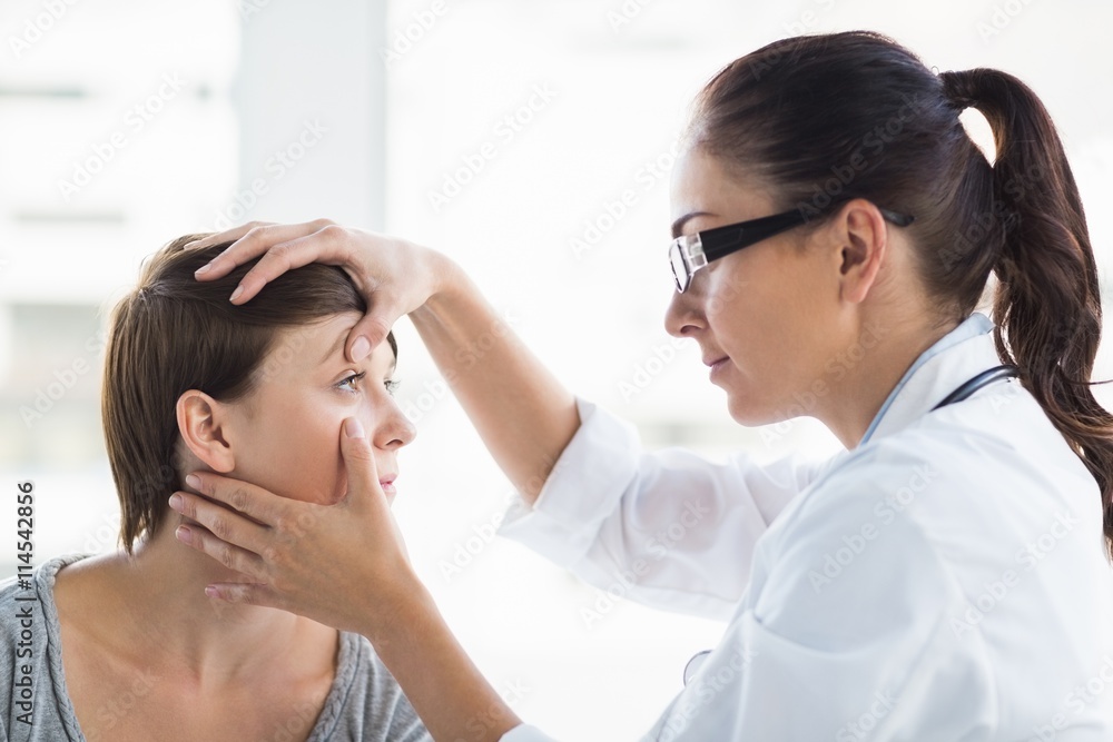 Doctor checking woman eye - obrazy, fototapety, plakaty 