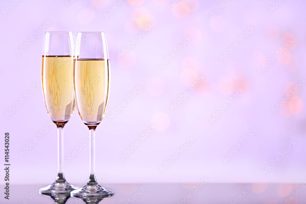 Two champagne glasses on light background Two champagne glasses on light background