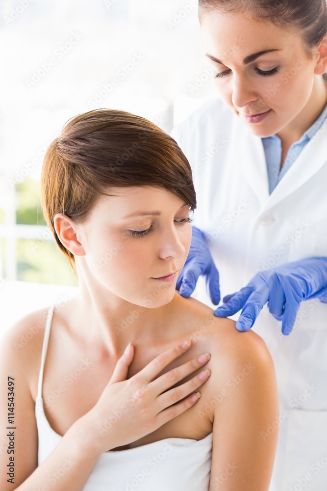 Doctor examining woman Doctor examining woman