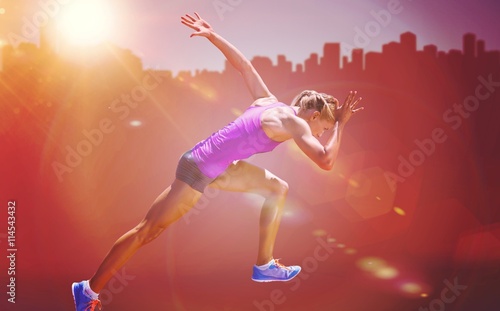 Fototapeta Naklejka Na Ścianę i Meble -  Composite image of athletic woman preparing to run