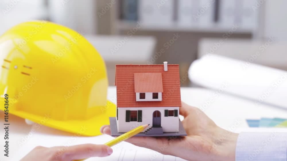 woman and architect discussing model of house woman and architect discussing model of house