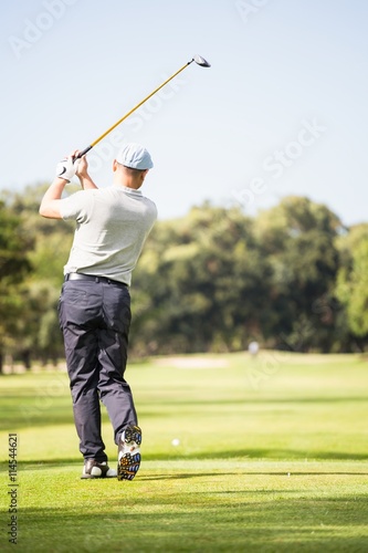 Golf player taking shot 