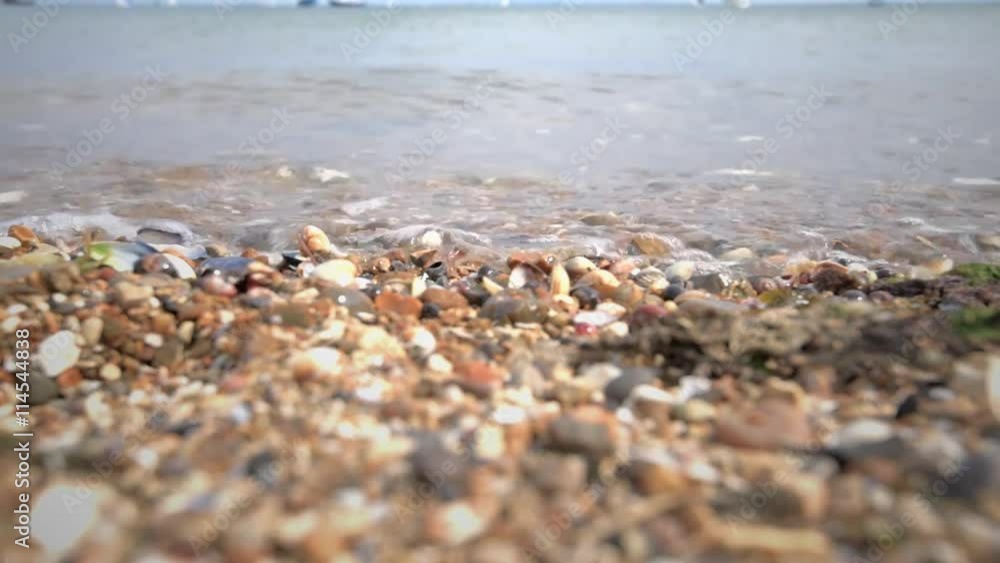 Close up of waves lapping up onto a stone and shingle beach. Footage taken Southend on Sea which is in Essex United Kingdom Close up of waves lapping up onto a stone and shingle beach. Footage taken Southend on Sea which is in Essex United Kingdom