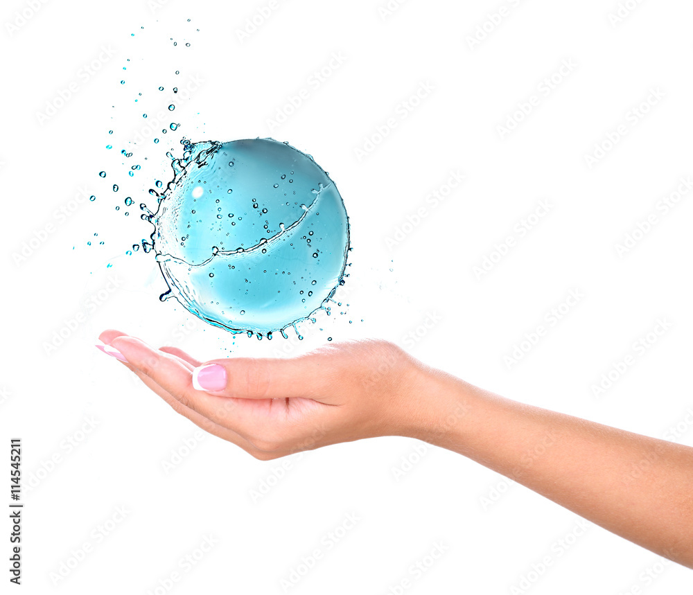 Female hand holding abstract water ball splash isolated on white