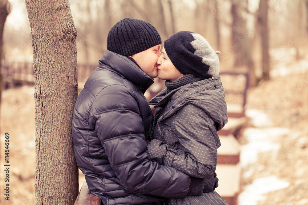 Happy Young Couple in Winter Park having fun.Family Outdoors. love Happy Young Couple in Winter Park having fun.Family Outdoors. love