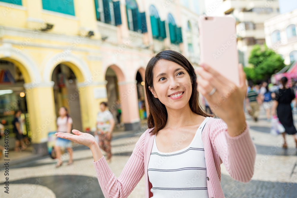 Woman taking self image by mobile phone in Macao city