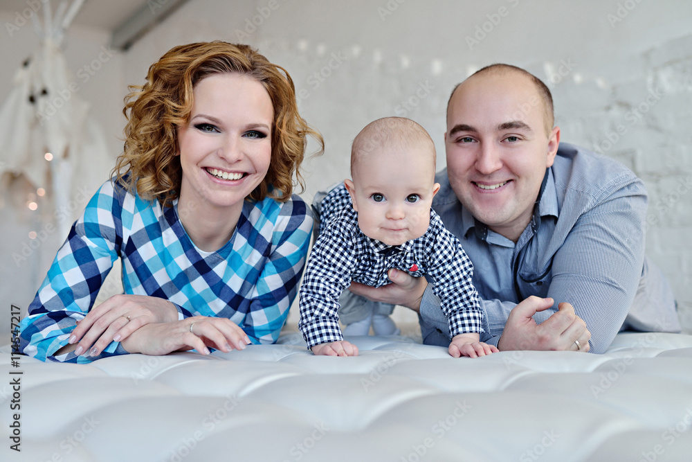 Portrait of the family. Father, mother and child. Female and male models indoors Portrait of the family. Father, mother and child. Female and male models indoors