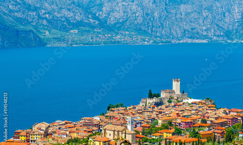 Top view to ancient tower and colorful houses in malcesine old