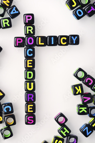 Colorful Dice with Word POLICY AND PROCEDURES on White Background