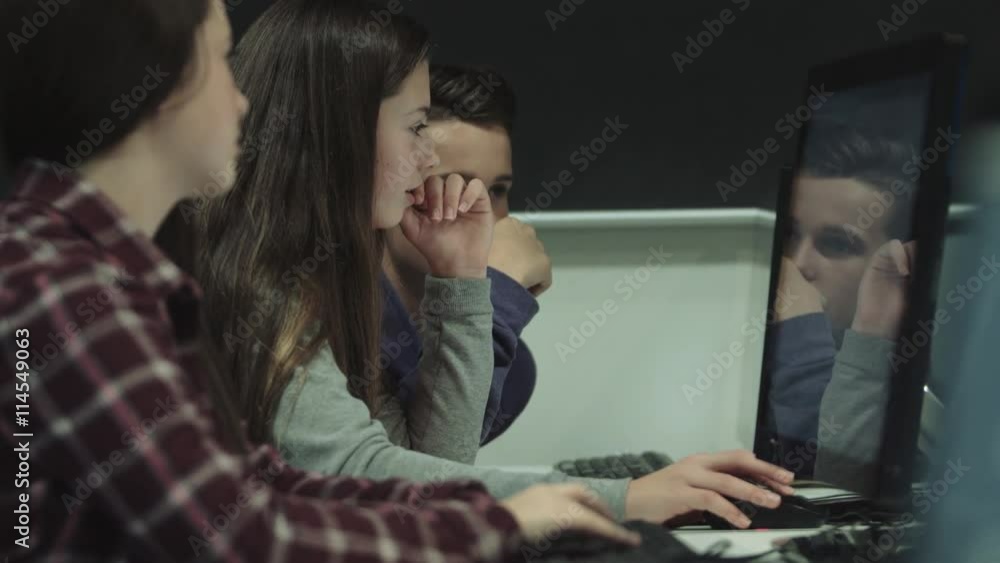 Teenage boy and girls working on computer in technology classroom Teenage boy and girls working on computer in technology classroom
