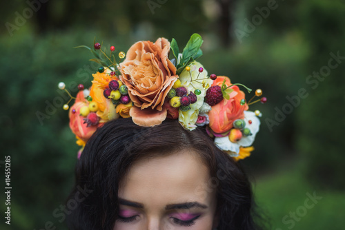 Attractive young woman with orange flowers crown