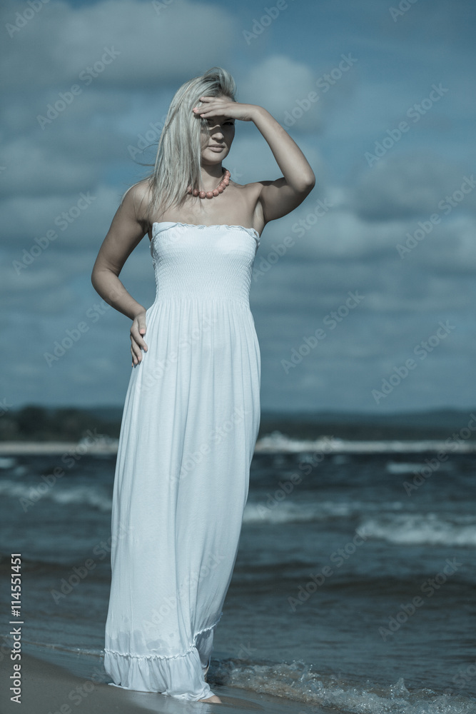 Female tourist walking on beach. Female tourist walking on beach.