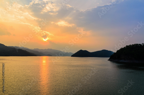 Beautiful landscape during sunset over a mountain ranges at lake in Srinakarin Dam  Kanchanaburi Province  Thailand