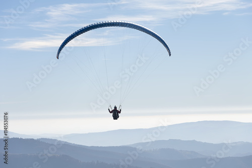 Paragliding flying in the sky.