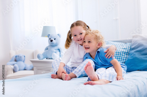 Kids playing in white bedroom