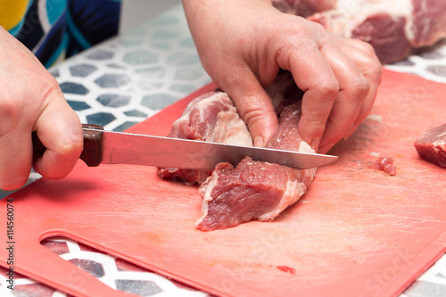 cutting meat with a knife