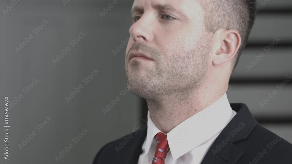 Businessman adjusting tie in mirror Businessman adjusting tie in mirror