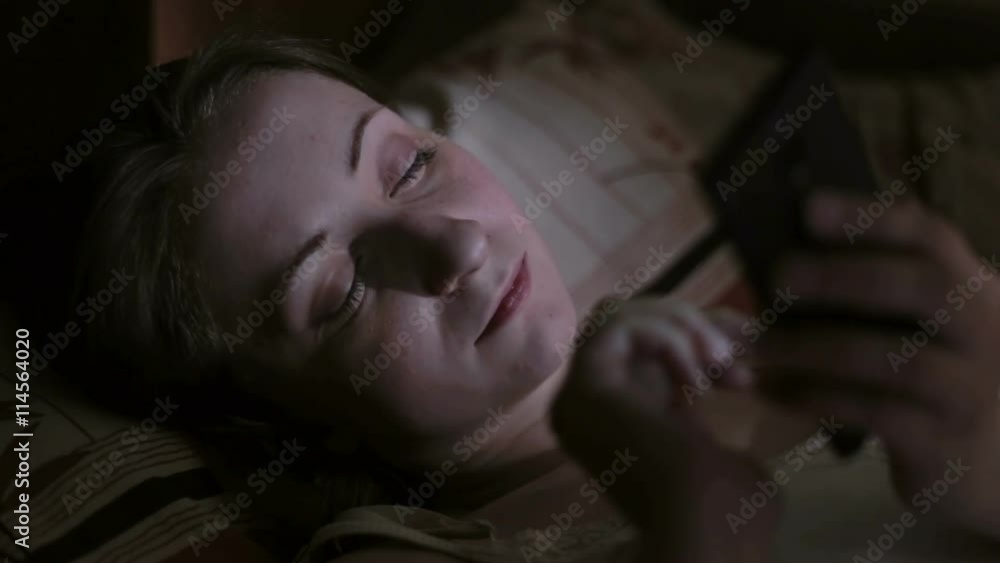 Attractive, young woman browsing photos or internet Attractive, young woman browsing photos or internet